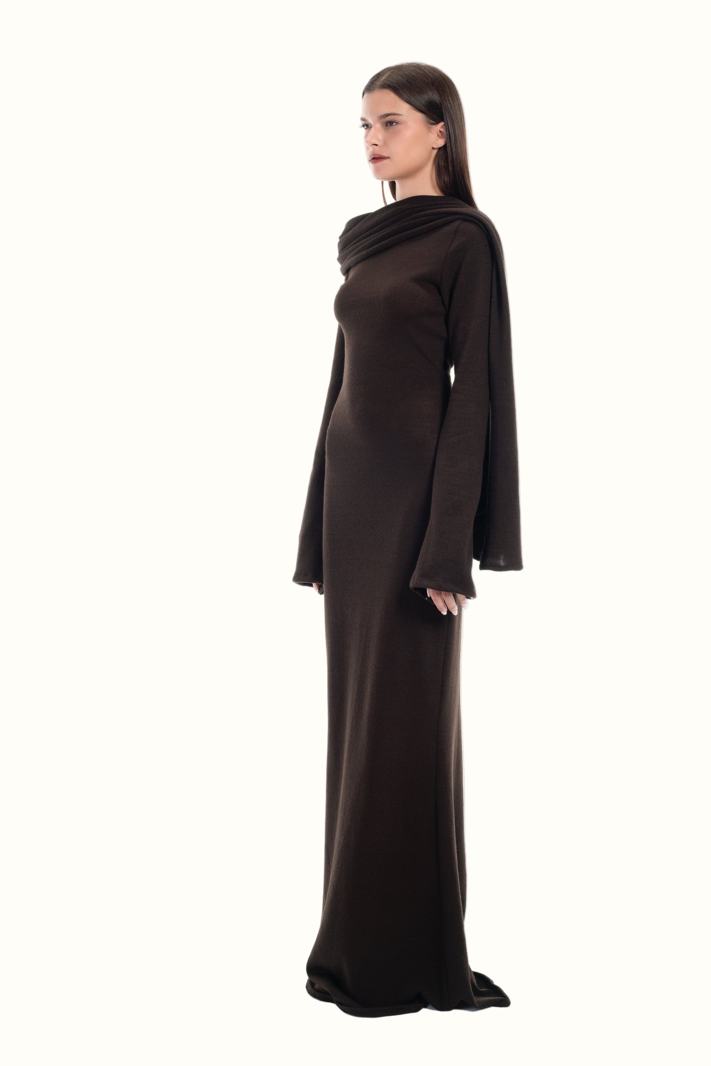 LUCE Woman wearing a maxi knit brown dress on a white background