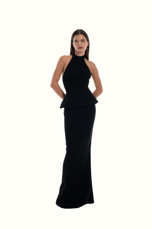 LUCE Woman wearing a black halter neck tailleur set on a white background
