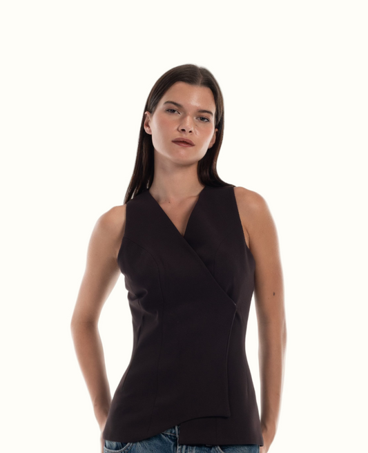 Woman wearing a dark brown waistcoat  with LUCE signature wave hem