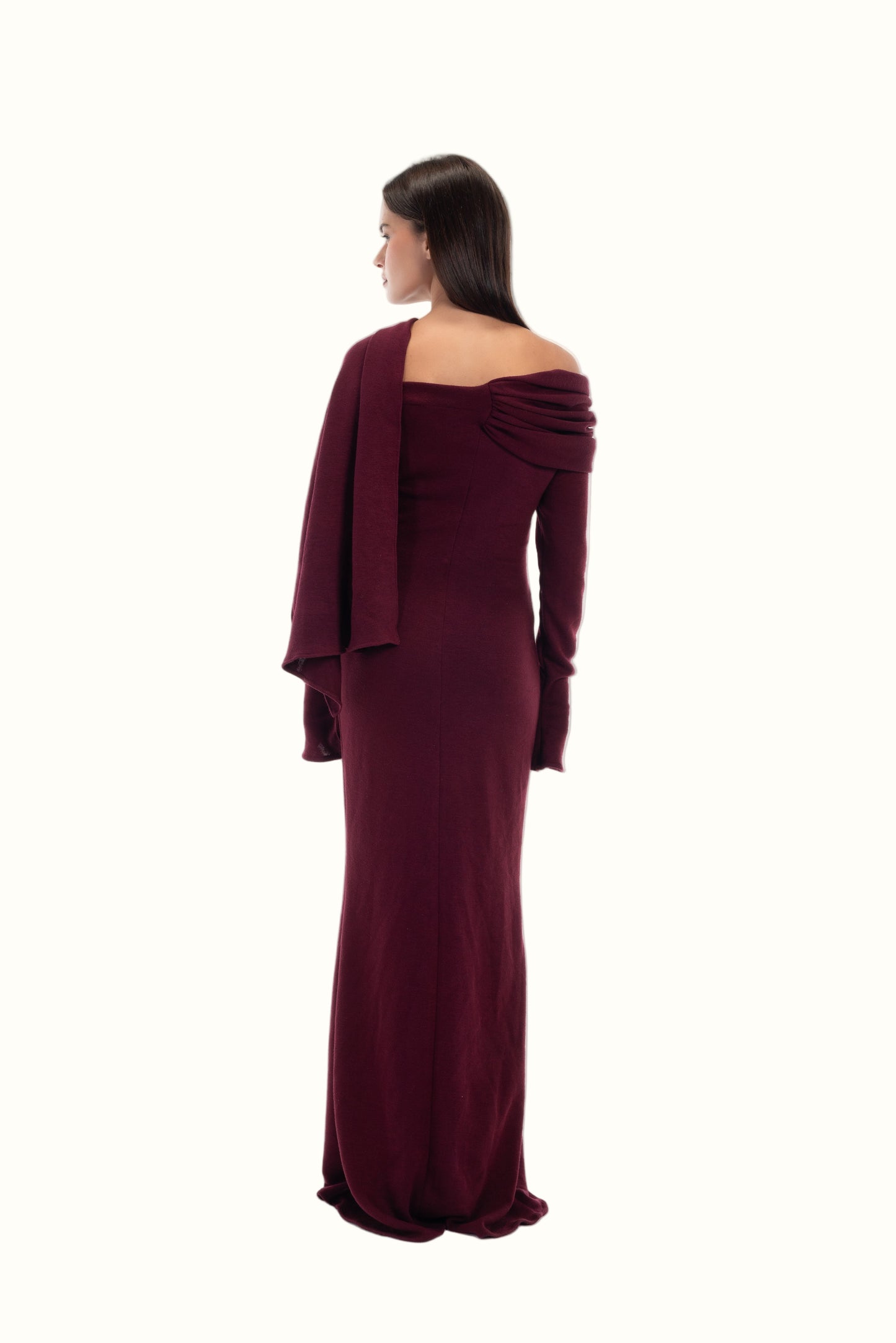 LUCE Woman wearing a burgundy off-shoulder dress with an attached scarf detail