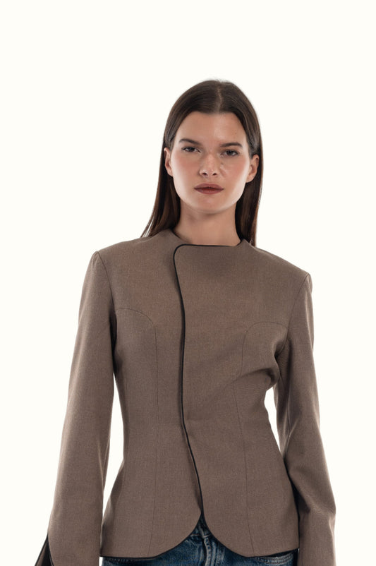 LUCE Woman wearing a brown blazer with black lining on a white background