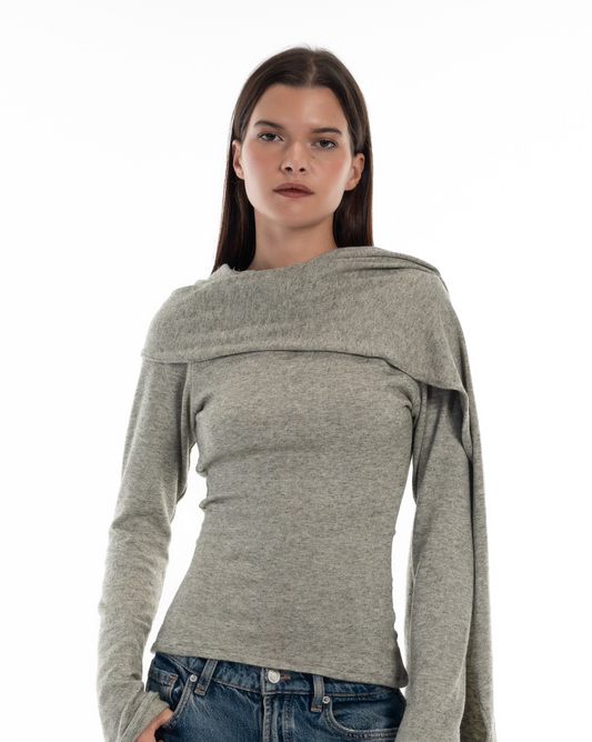 LUCE Woman wearing a gray long-sleeve cape top with scarf on a white background