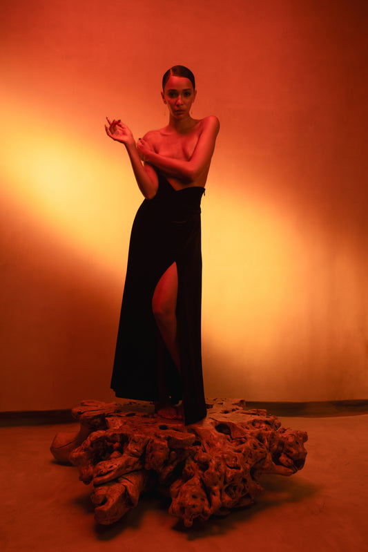LUCE girl wearing a velvet skirt with detail belt and a front slit